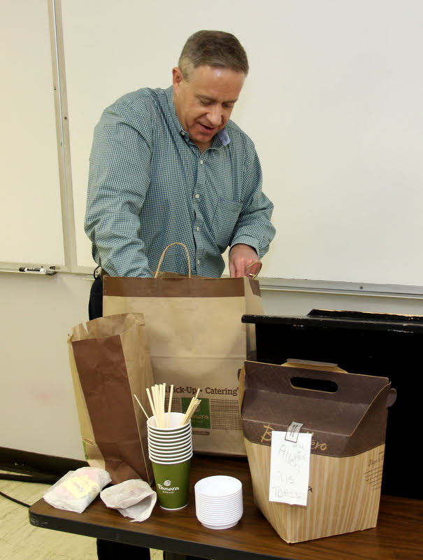Dr. Henry Allen puts refreshments in place prior to the Rutledge Honorary History Club's spring plenary meeting on March 18, 2019.