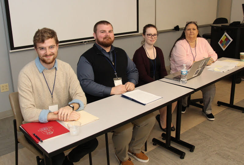 Union University student Luke Sower (left) sits with other members of the Phi Alpha Theta conference panel called 