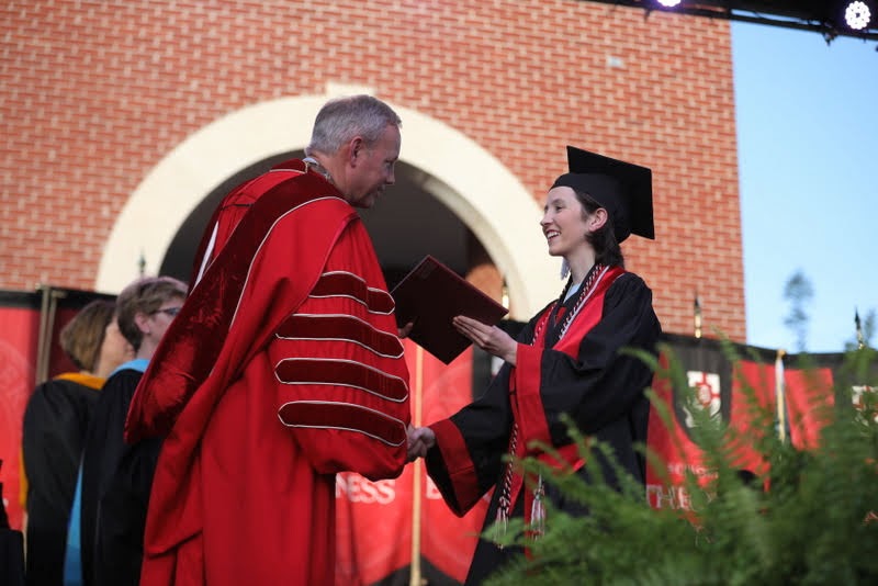 History major Lauren Butler receives her diploma from Dr. Samuel W. Dub Oliver during Union University's undergraduate commencement service on May 18, 2019. Photo by Kristi Woody