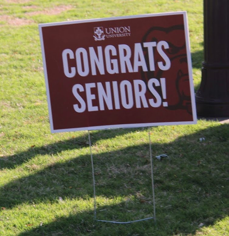 A sign along the processional route of the undergraduate commencement participants on May 18, 2019, offers congratulations to the graduating seniors.