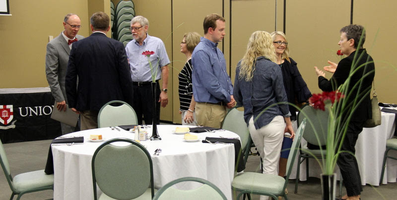 Attendees at the History Department Awards Banquet engage in conversation prior to the meal on May 2, 2019. They are (left to right) Robert Briley, Dr. Ray Van Neste (back to camera), Dr. Terry Lindley, Becky Lindley, Trebor Briley, Jennifer Briley (back to camera), Brenda Briley, and Dr. Alice-Catherine Carls.