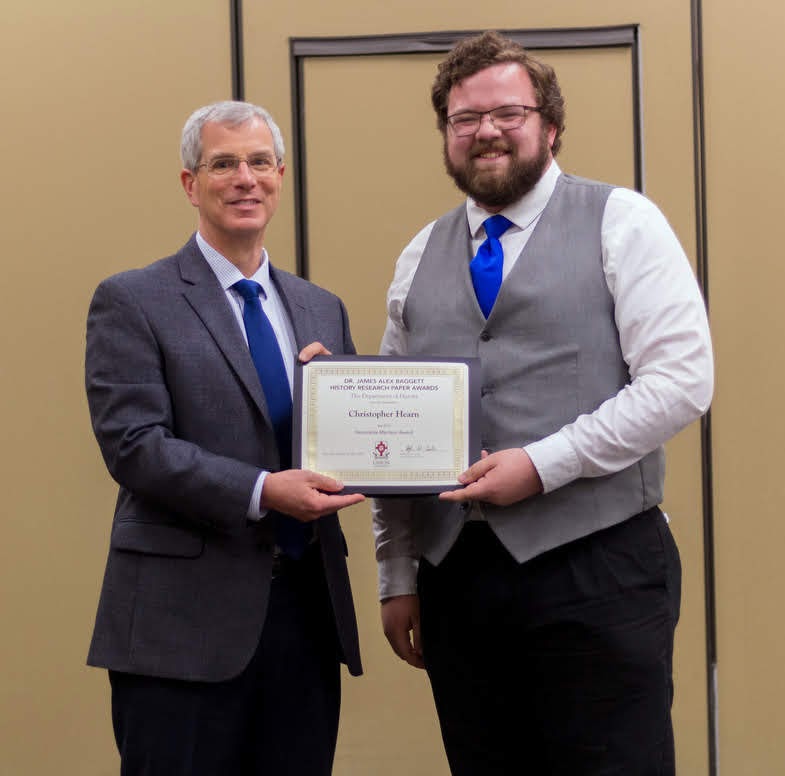 Dr. David Thomas (left) presents the Honorable Mention Award in the Dr. James Alex Baggett History Research Paper Competition to Christopher Hearn at the history awards banquet on May 2, 2019. Photo by Nicole Grim