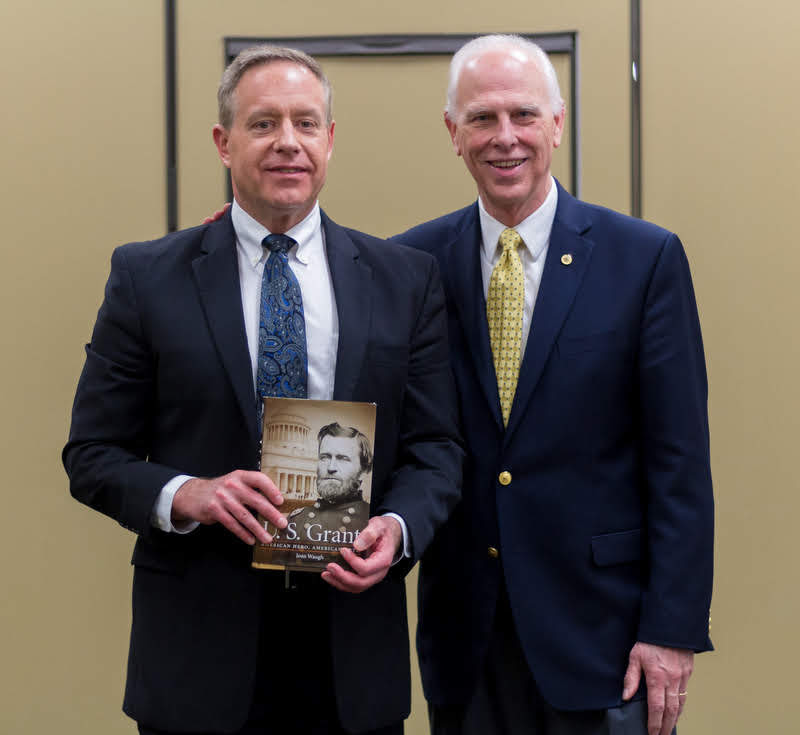 Dr. Henry Allen (left) receives congratulations and a book from Dr. Stephen Carls at the history awards banquet on May 2, 2019, for his promotion to the rank of associate professor of history. Photo by Nicole Grim
