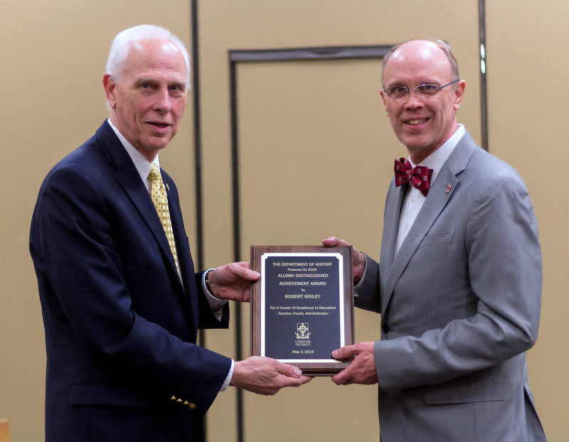 Robert Briley accepts the History Alumni Distinguished Achievement Award from Dr. Stephen Carls at the History Department Awards Banquet on May 2, 2019. Photo by Nicole Grim