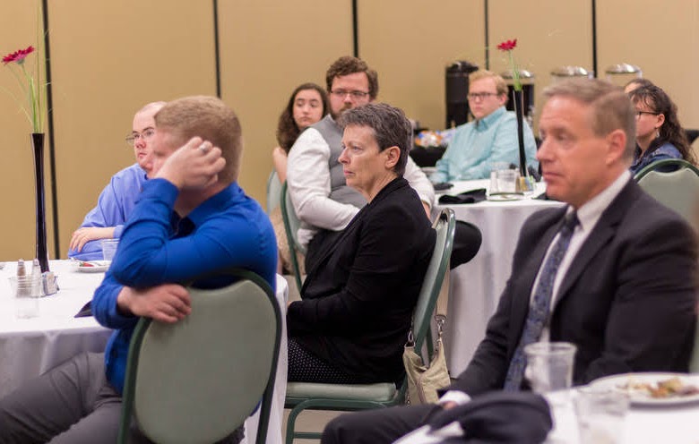 Dr. Alice-Catherine Carls (center) listens to Dr. Ray Van Neste speak about the importance of historical knowledge in decision-making at the history awards banquet on May 2, 2019. Photo by Nicole Grim