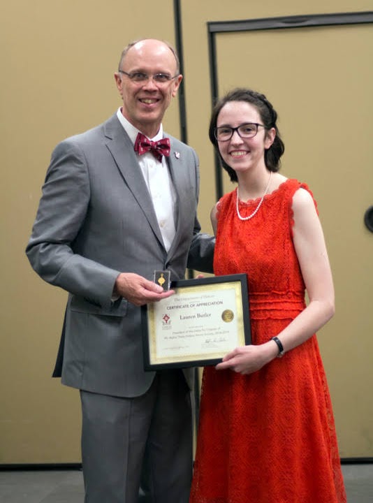 Lauren Butler accepts the Phi Alpha Theta Scholarship Pin and Academic Excellence Certificate from Robert Briley at the History Department Awards Banquet on May 2, 2019. Photo by Nicole Grim