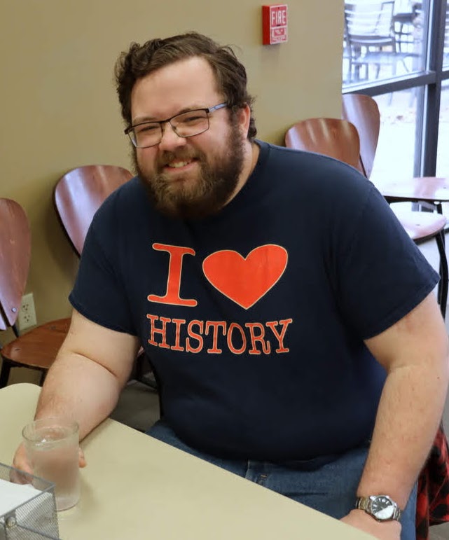 Christopher Hearn shows off his history T-shirt in the Union University cafeteria as part of the Delta-Psi chapter's Phi Alpha Theta T-shirt Spirit Day on March 9, 2020.