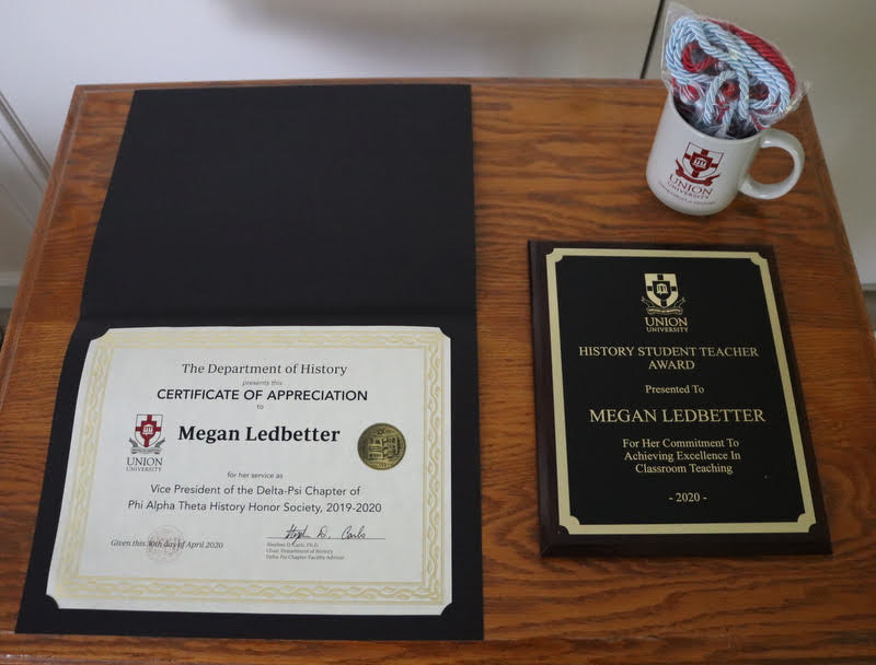 Graduating history major Megan Ledbetter received her History Student Teacher Award, Phi Alpha Theta honor cord, history department mug, and Certificate of Appreciation for her work as PAT Delta-Psi vice president in 2019-2020 via UPS in May 2020.