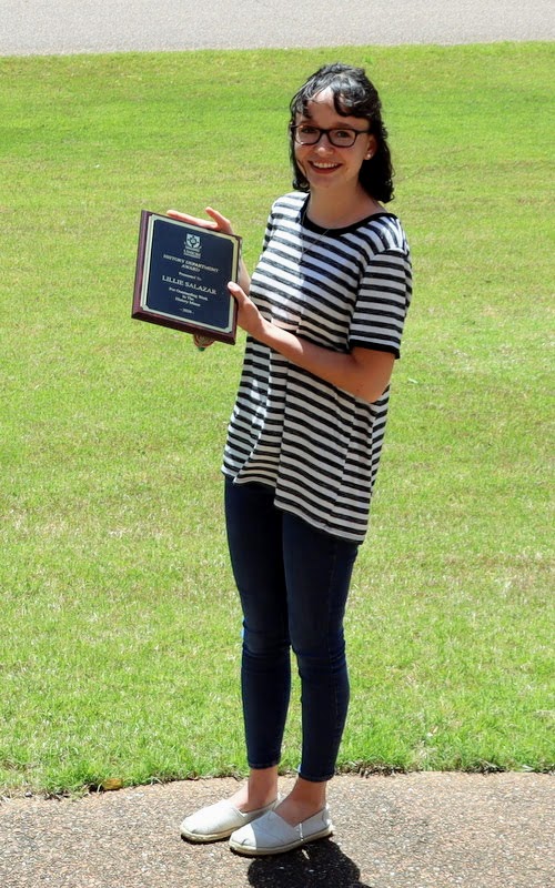 History minor Lillie Salazar displays her History Minor Award following a brief ceremony at Dr. Stephen Carls's home on April 30, 2020.