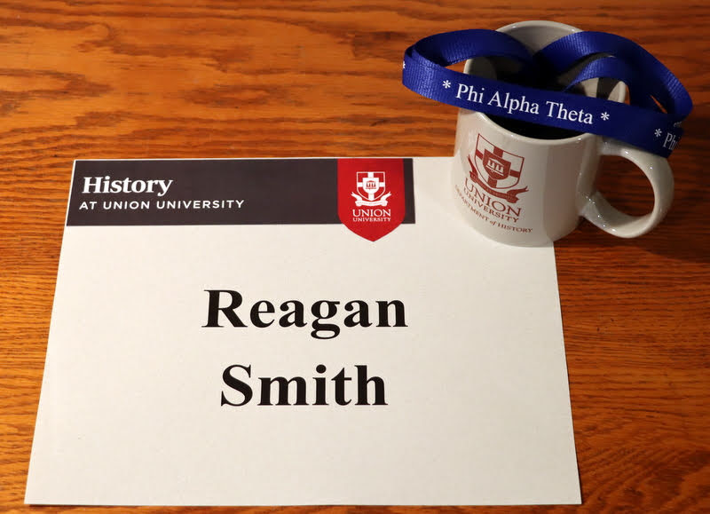 Graduating Phi Alpha Theta member Reagan Smith received a Phi Alpha Theta honor cord and a history department mug in the mail in May 2020.
