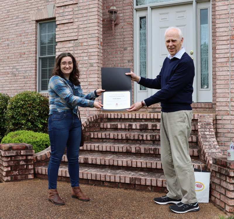 Graduating history major Leah Atkins accepts a certificate of appreciation from Dr. Stephen Carls for her work as president of the Rutledge Honorary History Club in 2019-2020.
