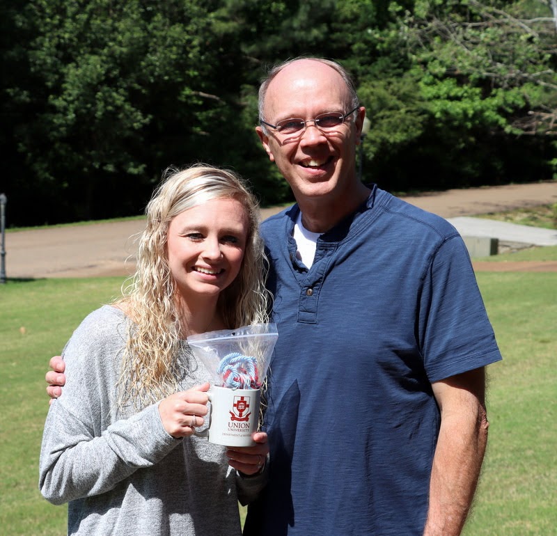 Graduating Phi Alpha Theta member Jennifer Briley stands with her father,  Robert Briley, after receiving her Phi Alpha Theta honor cord and history department coffee mug in May 2020.