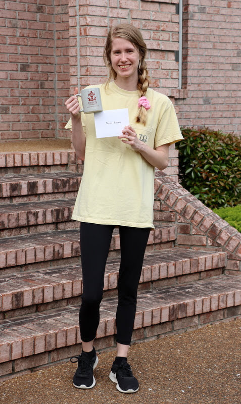 Graduating history major Taylor Brown displays her history department mug and  note of congratulations at Dr. Stephen Carls's home in May 2020.