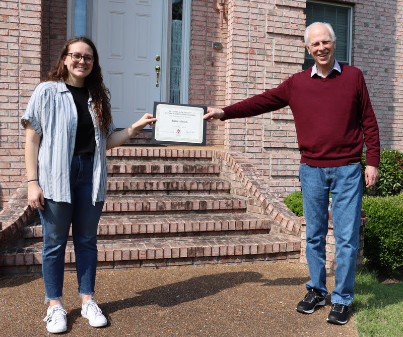 Katie Allison accepts her second place award in the Dr. James Alex Baggett History Research Paper Competition from Dr. Stephen Carls during a brief ceremony in May 2020.