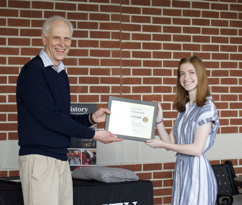 Savannah Wright accepts a certificate of appreciation from Dr. Stephen Carls on April 29, 2021, for her work as president of the Delta-Psi chapter of Phi Alpha Theta History Honor Society in 2020-2021. Photo by Naomi Mengel