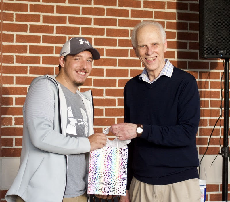 Noah Ross (left), a graduating history major, accepts a history gift award from Dr. Stephen Carls on April 29, 2021. Photo by Naomi Mengel