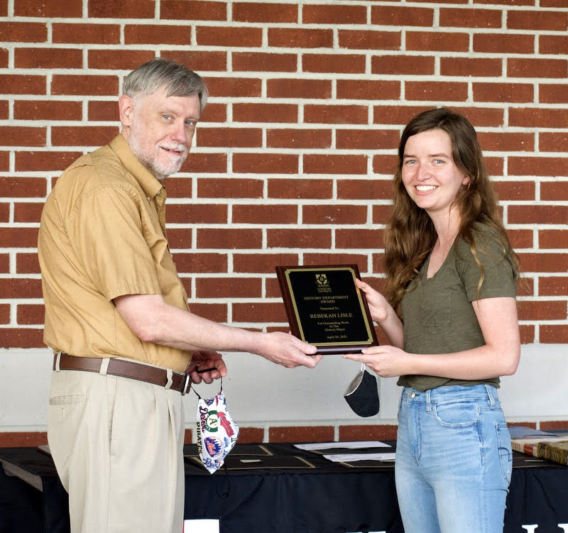 Dr. Terry Lindley presents a History Major Award to Rebekah Lisle on April 29, 2021. Photo by Naomi Mengel