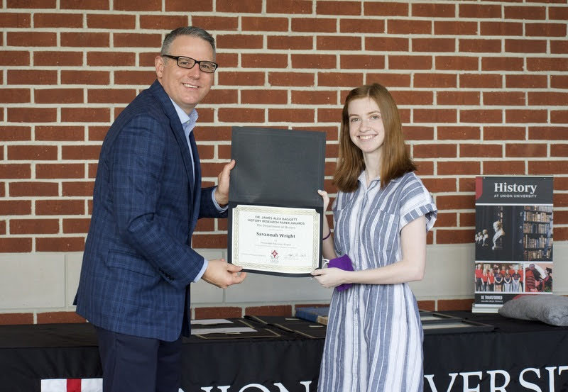 Dr. Keith Bates gives an honorable mention certificate to Savannah Wright on April 29, 2021, for her paper in the Dr. James Alex Baggett History Research Paper Competition. Photo by Naomi Mengel