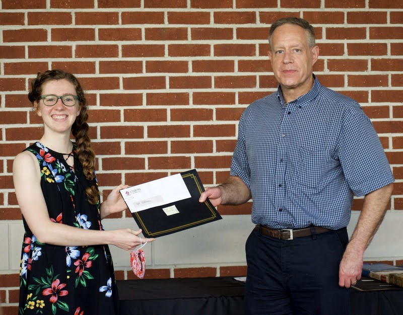 Anne Adams accepts a third-place award from Dr. Henry Allen on April 29, 2021, in the Dr. James Alex Baggett History Research Paper Competition. Photo by Naomi Mengel
