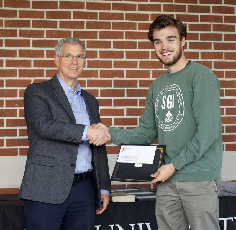Dr. David Thomas (left) congratulates Jack Waters on April 29, 2021, on winning the second-place prize in the Dr. James Alex Baggett History Research Paper Competition. Photo by Naomi Mengel