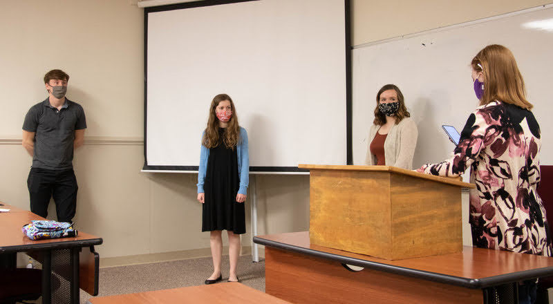 Phi Alpha Theta President Savannah Wright (right) leads the membership oath for new members (left to right) Tad Binkley, Anne Adams, and Abbie Hobson at the Delta-Psi chapter’s spring plenary meeting on March 10, 2021. Photo by Joey Echeverria