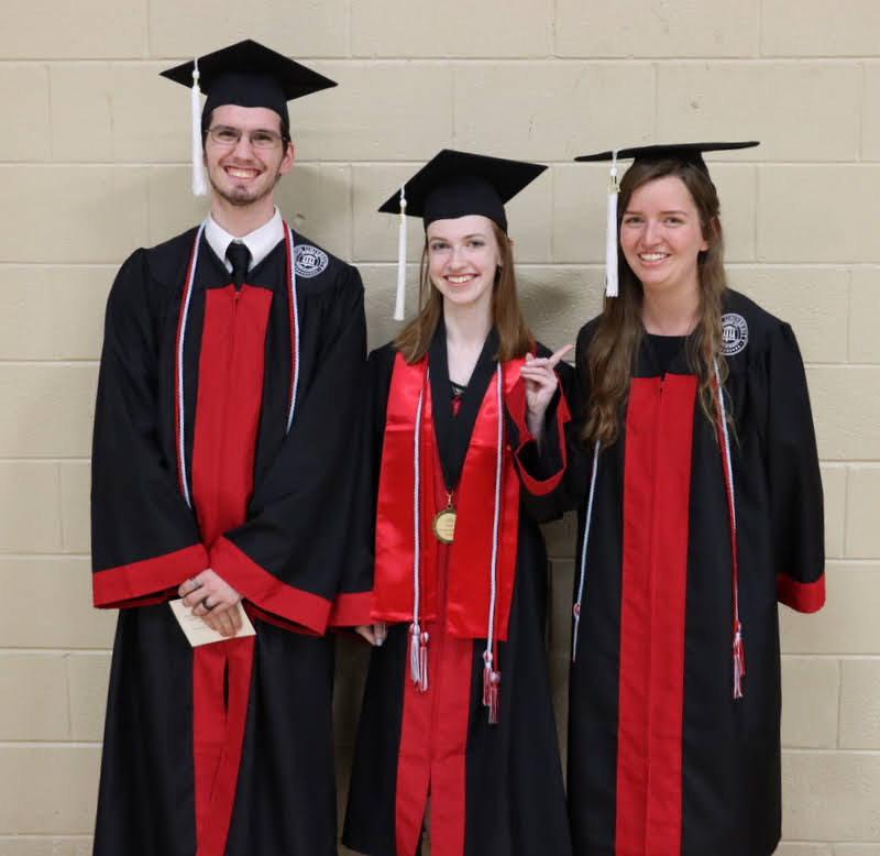 History majors and Phi Alpha Theta members Matthew Latham (left to right), Savannah Wright, and Rebekah Lisle get ready for Union University's spring graduation for traditional undergraduates on May 15, 2021.