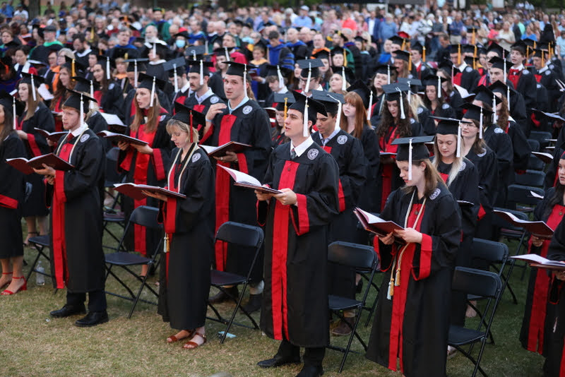 Newly graduated students participate in the singing of Union University's Alma Mater at the end of the school's  commencement for traditional undergraduates on May 15, 2021. Photo by Kristi Woody
