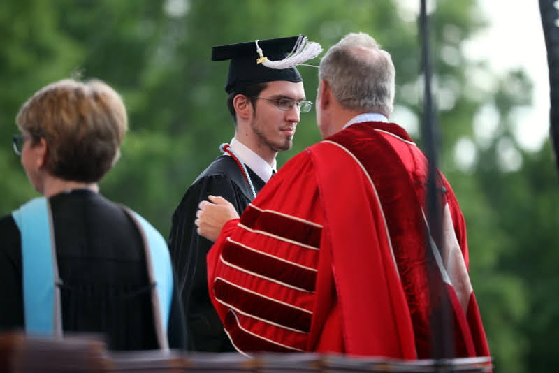 History major Matthew Latham receives his bachelor of arts diploma from Union University President Samuel W. Dub Oliver on May 15, 2021. Photo by Kristi Woody