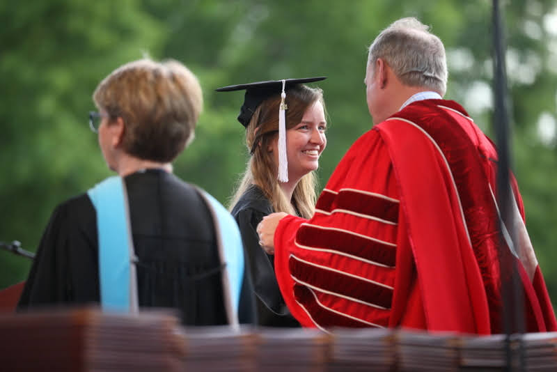 History major Rebekah Lisle receives her bachelor of arts diploma from Union University President Samuel W. Dub Oliver on May 15, 2021. Photo by Kristi Woody