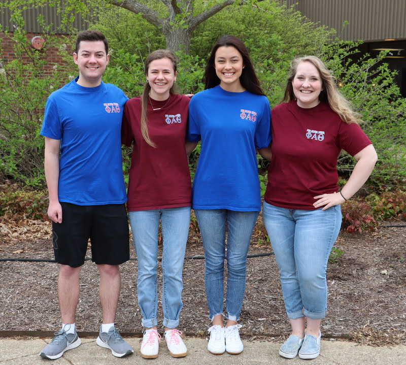 Delta-Psi chapter officers for 2022-2023 stand together at the club's Phi Alpha Theta T-shirt Spirit Day on April 11, 2022. They are (left to right) Jack Jenkins, secretary; Anna Yadkowski, senator; Makayla Baker, senator; and Breanna Edmiston, vice president. Chapter President Tad Binkley was unable to attend the photo session owing to another engagement.