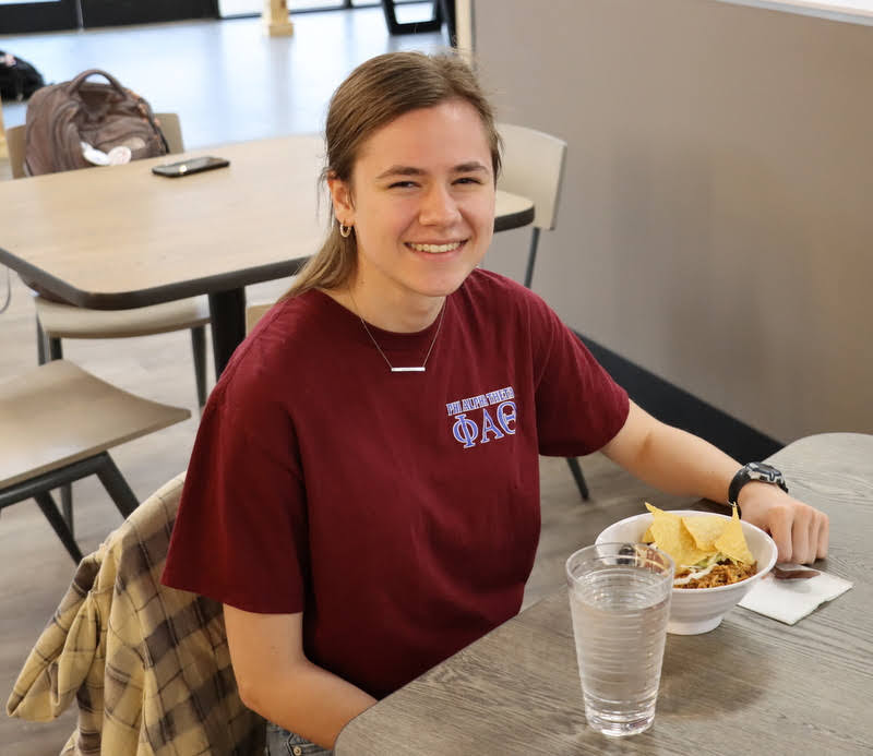 Delta-Psi chapter member Anna Yadkowski wears her Phi Alpha Theta T-shirt during lunch in Union's cafeteria on April 11, 2022.