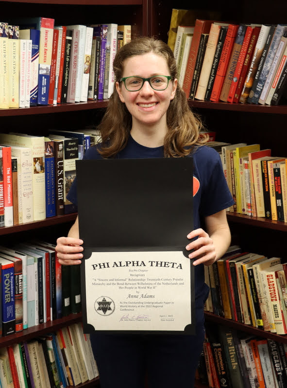 Anne Adams holds the award certificate she won for the best undergraduate paper in world history at the Arkansas Phi Alpha Theta Regional Conference at Harding University on April 2, 2022.