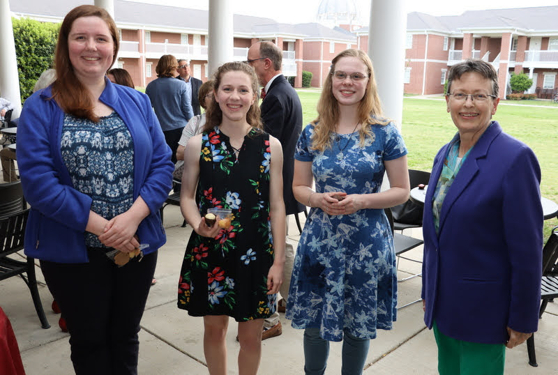 History club members Abigail Gilbert (left) and Anna Guelcher (second from right) stand with Phi Alpha Theta member Anne Adams (second from left) and Dr. Alice-Catherine Carls (right) prior to the History Department Awards Program on the patio of the Bowld Commons on April 28, 2022.