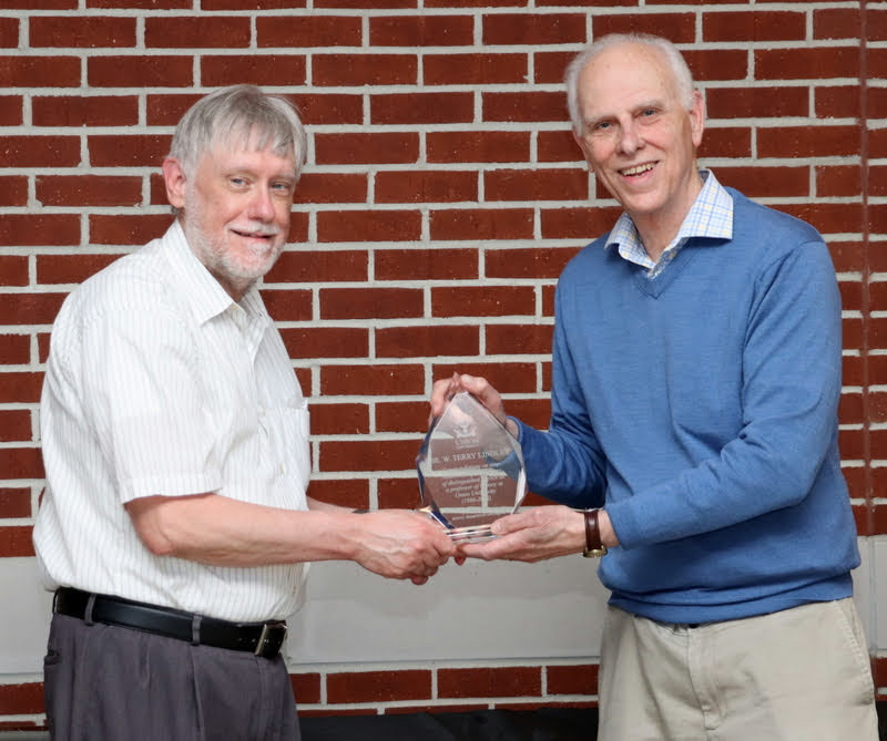 Dr. Terry Lindley (left) accepts a crystal award from Dr. Stephen Carls at the History Department Awards Program on April 28, 2022, as a retirement gift from his history colleagues for his  36 years of faithful service as a professor of history at Union University.