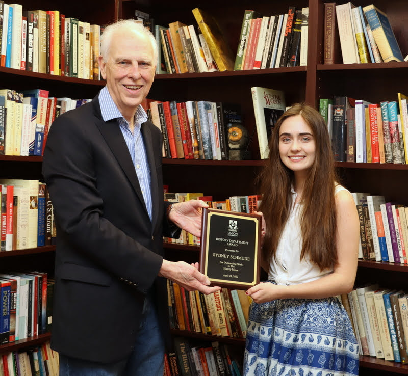 Dr. Stephen Carls presents the 2022 History Minor Award to Sydney Schmude in a special ceremony in his office on May 2, 2022.