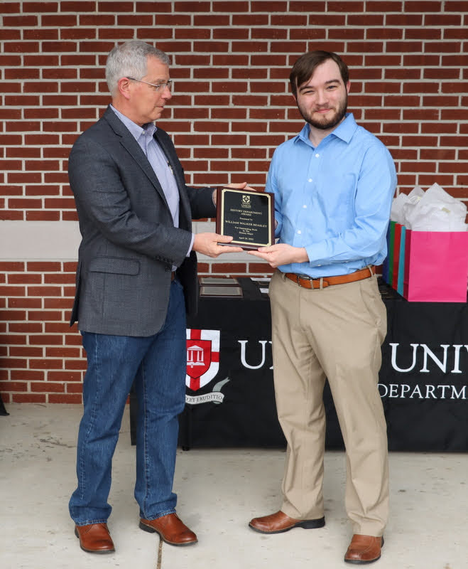 Walker Beasley (right) accepts a History Major Award from Dr. David Thomas at the History Department Awards Program on April 28, 2022 for his excellent work in his history classes at Union.