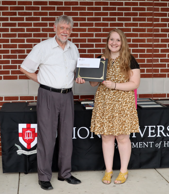 Dr. Terry Lindley presents the third place prize in the 2022 Dr. James Alex Baggett History Research Paper Competition to Breanna Edmiston at the History Department Awards Program on April 28, 2022.