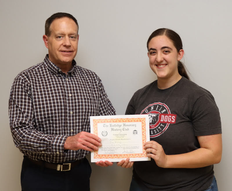 Dr. Henry Allen presents Joy Brown with her Rutledge Honorary History Club membership certificate at the club's spring plenary meeting on April 7, 2022.