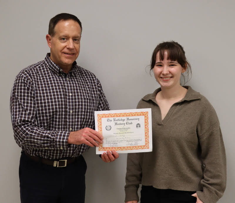 Dr. Henry Allen presents Sophia Keskeys with her Rutledge Honorary History Club membership certificate at the club's plenary meeting on April 7, 2022.