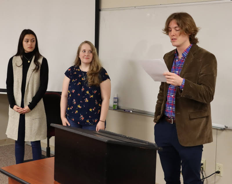 Delta-Psi Chapter Vice President Tad Binkley leads the induction ceremony for the two newest members of Phi Alpha Theta at Union University - Makayla Baker (left) and Breanna Edmiston - at the chapter's initiation/plenary meeting on February 28, 2022. Photo by Stephen Carls