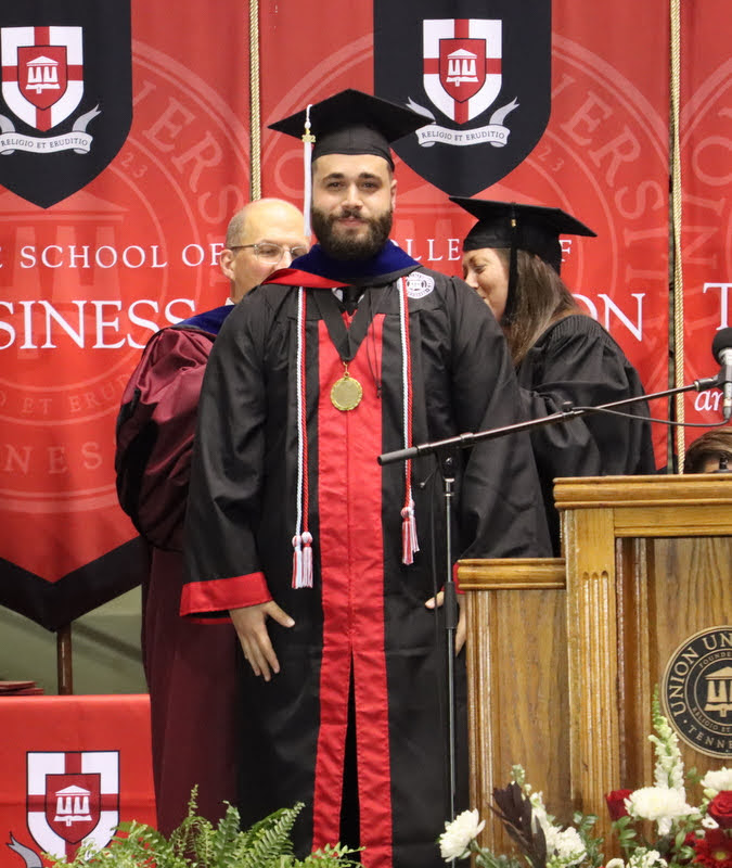 Nicholas Terra is hooded at Union's undergraduate commencement on May 21, 2022, by Dr. Scott Huelin and Professor Joy Moore of the Honors Community for completing the discipline-specific honors program in philosophy. Terra had a double major in history and philosophy.