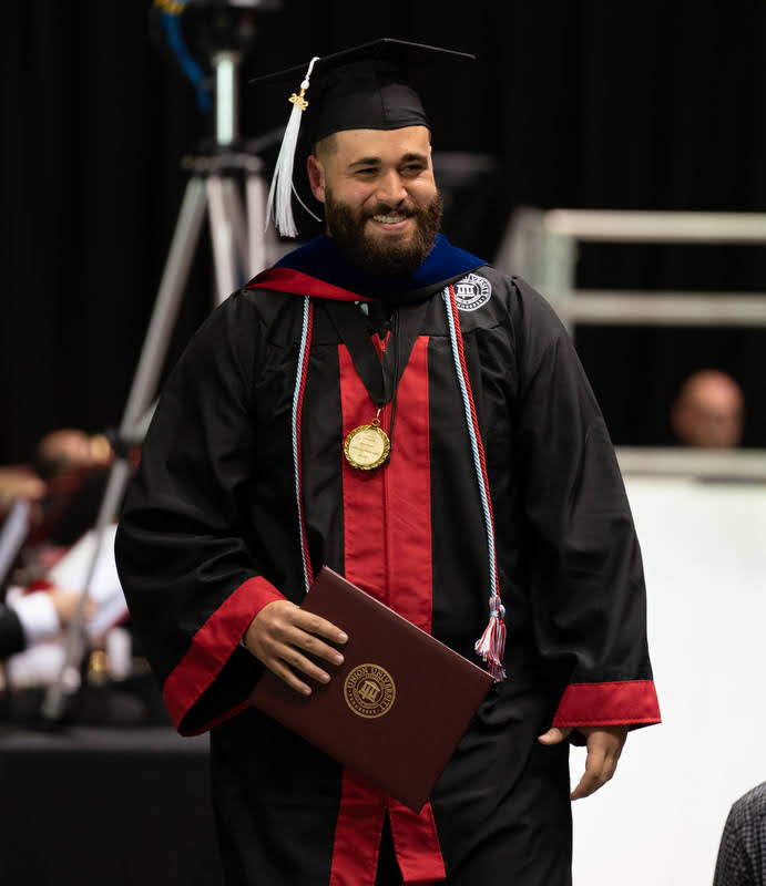History major Nicholas Terra expresses delight after receiving his bachelor of arts diploma at Union University's undergraduate commencement ceremony on May 21, 2022. Photo by Kristi Woody