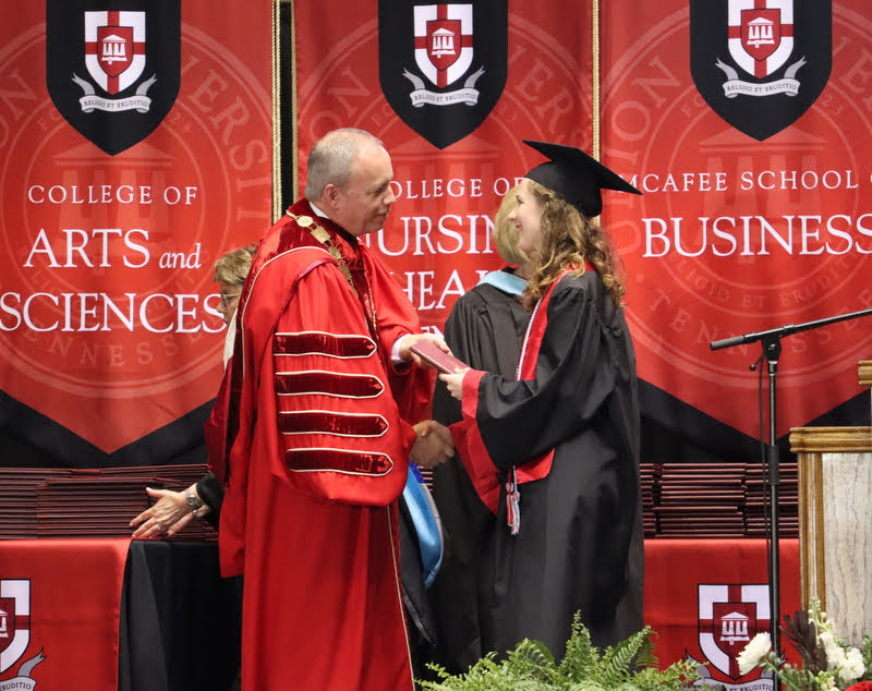 Anne Adams accepts congratulations and her bachelor of arts diploma from President Samuel W. Dub Oliver at Union's undergraduate commencement ceremony on May 21, 2022.