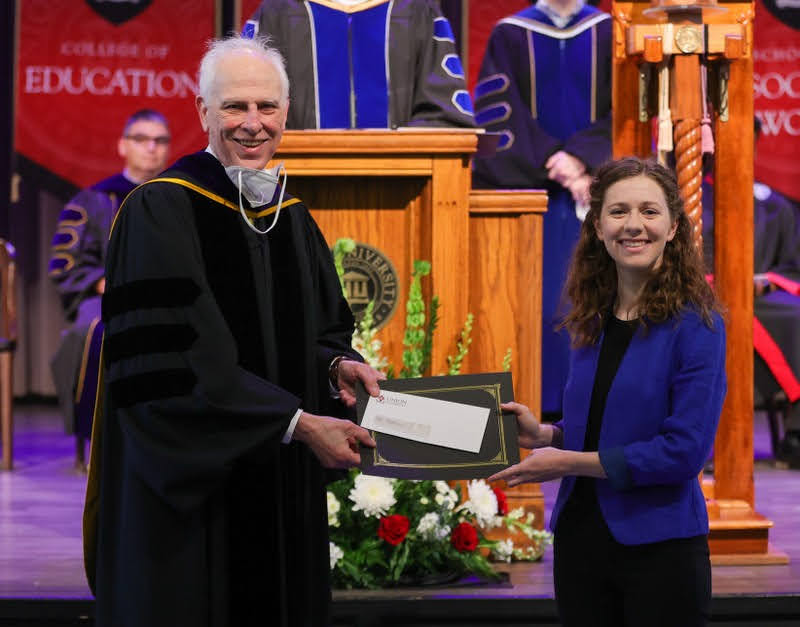 Anne Adams accepts the first place award in the 2022 Dr. James Alex Baggett History Research Paper Competition from Dr. Stephen Carls at the Union University Awards Convocation on May 6, 2022. Photo by Suzanne Rhodes