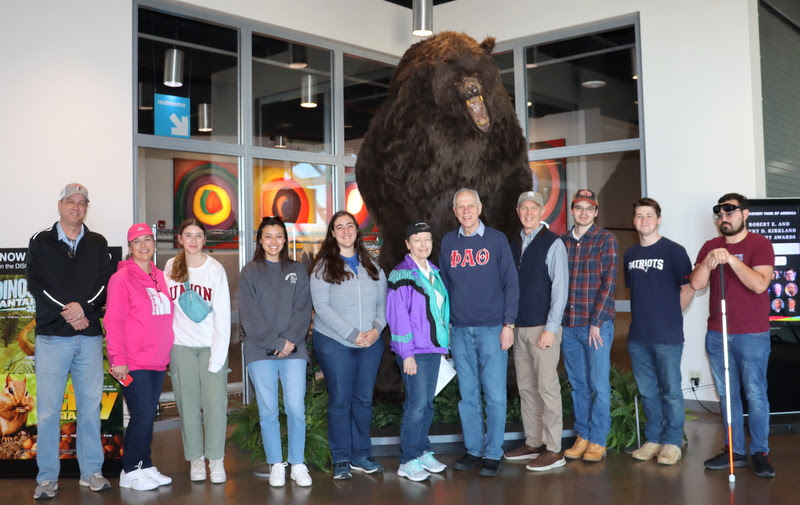 Participants in Union's Phi Alpha Theta field trip to Discovery Park of America in Union City stand in front of a stuffed giant cave bear at the beginning of their visit on April 1, 2023. They are (left to right) Steve Jahnke, Carol Lynn Jahnke, Madeline Jahnke, Makayla Baker, Joy Brown, Dr. Alice-Catherine Carls, Dr. Stephen Carls, Robert Briley, William Houston, Noah Kea, and Chris Young.