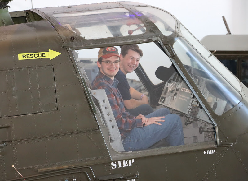 William Houston (front) and Noah Kea (behind) sit in the cockpit of a UH-34D Helicopter in the Military Gallery of Discovery Park of America on April 1, 2023.