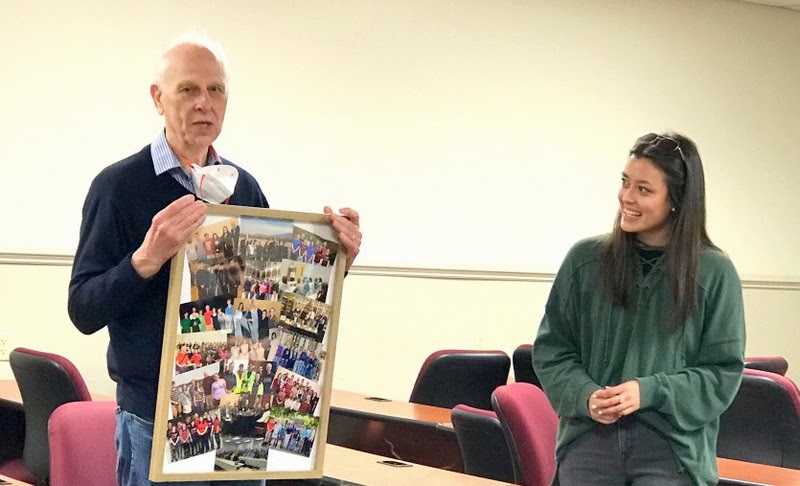 Dr. Stephen Carls thanks Phi Alpha Theta President-elect Makayla Baker on April 24, 2023, for the framed photo collage depicting scenes from his many years as the faculty advisor to Union's Delta-Psi chapter.