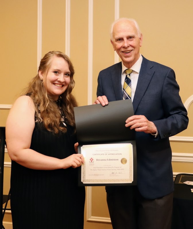 Dr. Stephen Carls presents a certificate of appreciation to Breanna Edmiston at the History Department Awards Banquet on April 27, 2023, for her work as vice president of Union's Delta-Psi chapter of Phi Alpha Theta History Honor Society in 2022-2023.