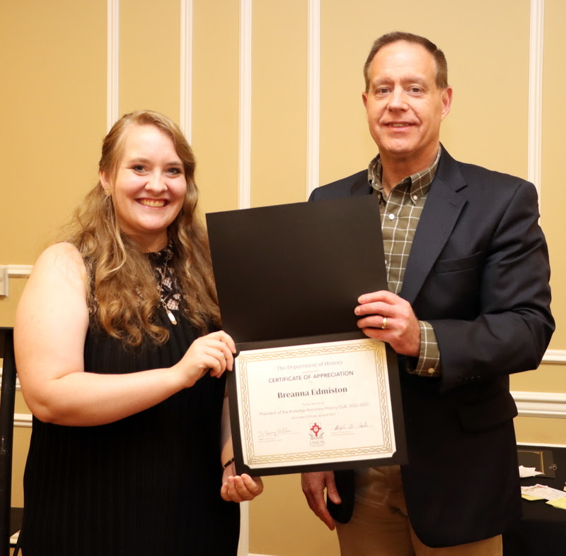 Dr. Henry Allen presents a certificate of appreciation to Breanna Edmiston at the History Department Awards Banquet on April 27, 2023, for her work as president of the Rutledge Honorary History Club in 2022-2023.