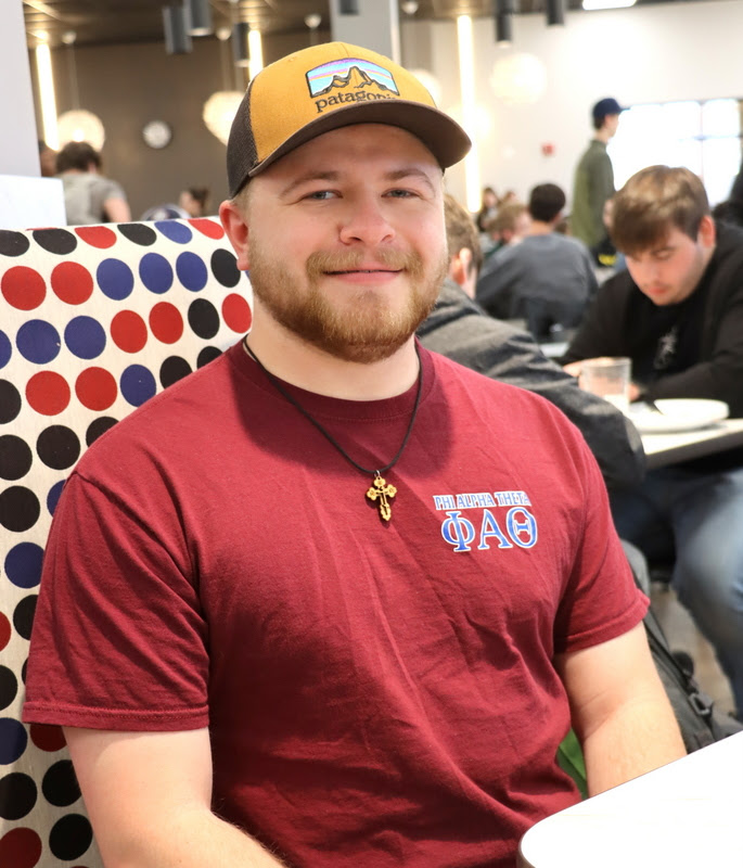 Delta-Psi chapter member John Garland takes time for a photo wearing his Phi Alpha Theta T-shirt during lunch in Union's cafeteria on March 20, 2023. He participated in the chapter's Annual Phi Alpha Theta Spirit Day.